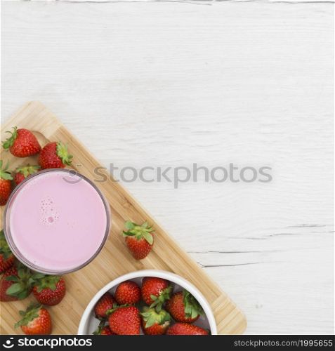flat lay strawberry smoothie with fruits