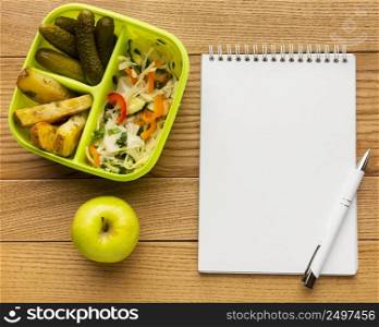 flat lay tasty meal composition with empty notebook