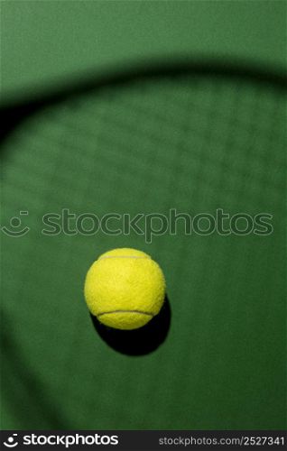 flat lay tennis ball with racket shadow