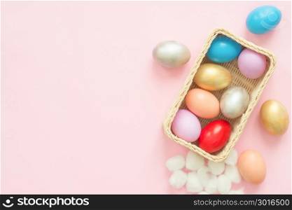 Flat lay top view colorful easter egg painted in pastel colors composition on pink pastel color background. Easter day background top view with copy space.