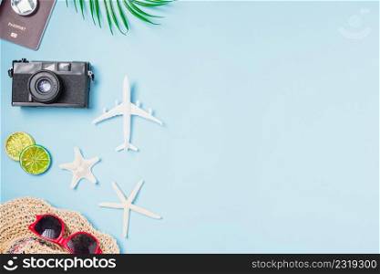 Flat lay top view mockup retro camera films, airplane, starfish, shells, hat traveler tropical accessories on a blue background with copy space, Business trip, and vacation summer travel concept