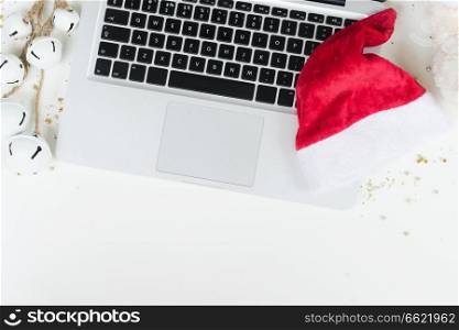 Flat lay, top view office table desktop. Workspace with laptop and christmas decorations on white background. Christmas mock up