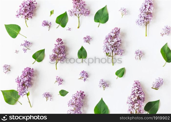 Flat lay top view photo of a pattern made of a lilac flowers, leaves and petals. Naturals rustic spring photography.. Flat lay top view photo of a pattern made of a lilac flowers, leaves and petals.
