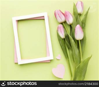 flat lay tulips bouquet beside frame