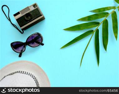 Flat lay vacation stuff on blue background. Travel or vacation concept. Summer background.