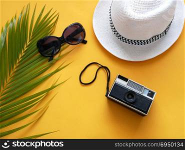 Flat lay vacation stuff on yellow background. Travel or vacation concept. Summer background.