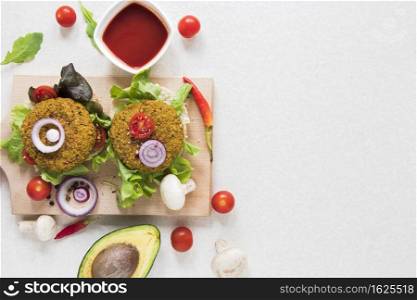 flat lay vegan burgers wooden board with copy space
