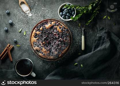 Flat lay with delicious homemade blueberry pie on dark background