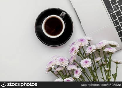 flat lay with flowers laptop with cup coffee