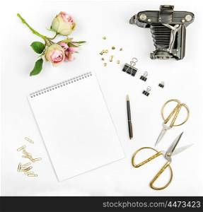 Flat lay with photo album, flowers, vintage camera, scissors on white background. Mock up