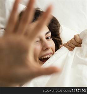 flat lay woman hiding sheets home