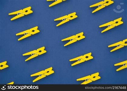 flat lay yellow clothes pins blue background
