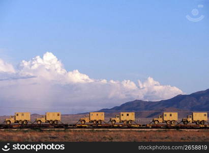 Flatbed train cars transporting trucks, Arizona