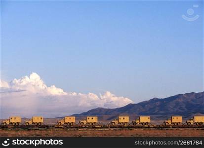 Flatbed train cars transporting trucks, Arizona