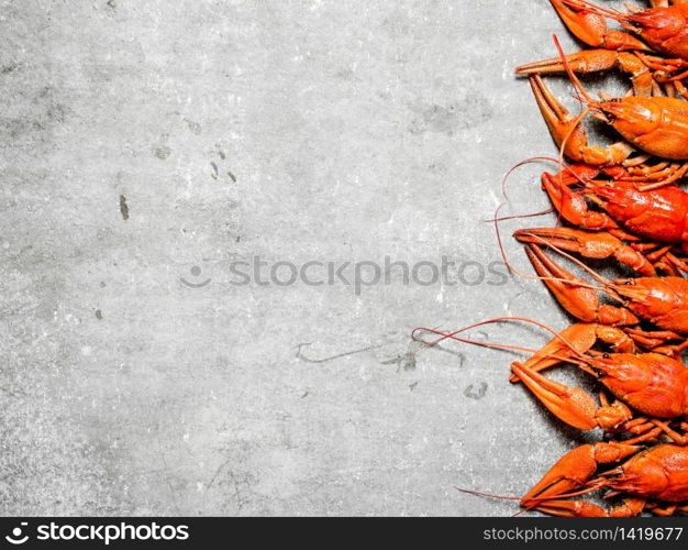 Flavorful boiled crawfish. On a stone background.. Flavorful boiled crawfish.