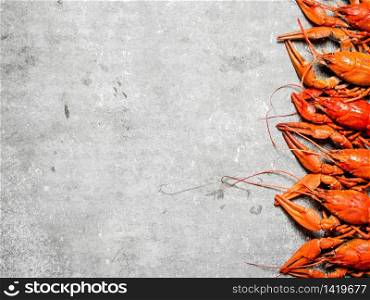 Flavorful boiled crawfish. On a stone background.. Flavorful boiled crawfish.