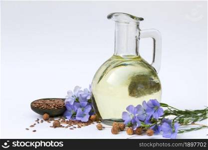 flax oil bottle with flowers and seeds isolated on white background. bottle of flax oil with flowers and seeds