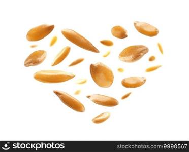 Flax seeds are in the shape of a heart on a white background.. Flax seeds are in the shape of a heart on a white background