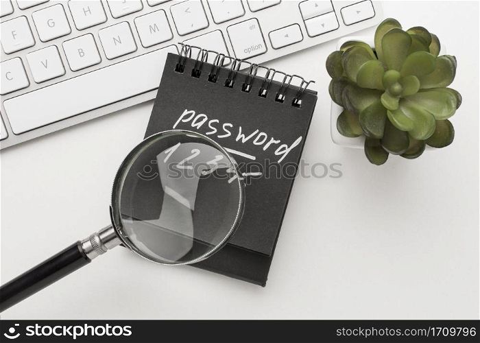 flay lay notebook with password info magnifying glass