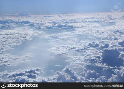 Flight above clouds. Panorama from window of plane with white clouds. Flying over white clouds. White clouds below. Beautiful panorama with heaven. Panorama from window of plane with white clouds