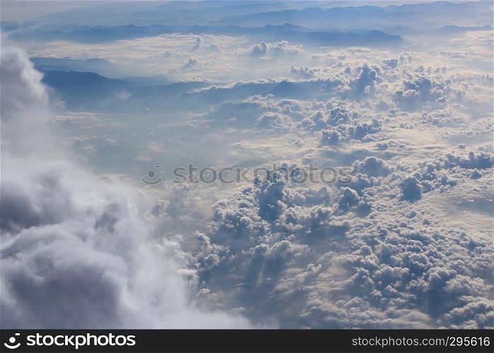 Flight above clouds. Panorama from window of plane with white clouds. Flying over white clouds. White clouds below. Beautiful panorama with heaven. Panorama from window of plane with white clouds