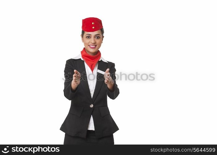 Flight attendant gesturing towards exits over white background