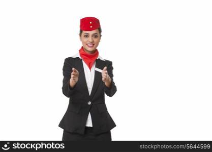 Flight attendant gesturing towards exits over white background