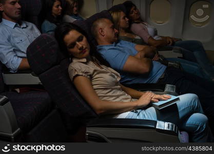 Flight passengers sleeping plane cabin night travel