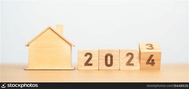 flip 2023 to 2024 block with house model. real estate, Home loan, tax, investment, financial, savings and New Year Resolution concepts