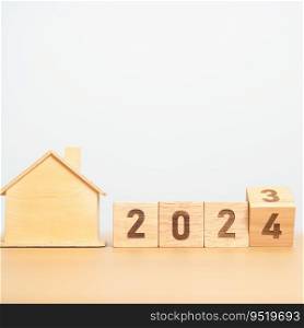 flip 2023 to 2024 block with house model. real estate, Home loan, tax, investment, financial, savings and New Year Resolution concepts