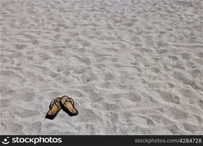 Flip flop sandals on the sandy beach