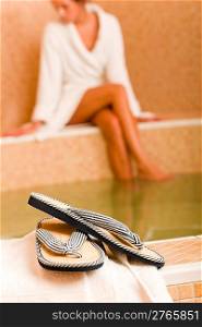 Flip-flops close-up relax spa pool woman wear bathrobe