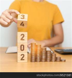 flipping 2023 to 2024 year block with Coins stack. Money, Budget, tax, investment, financial, savings and New Year Resolution concepts