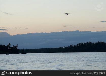 Float plane in the sky over Lake of the Woods, Ontario