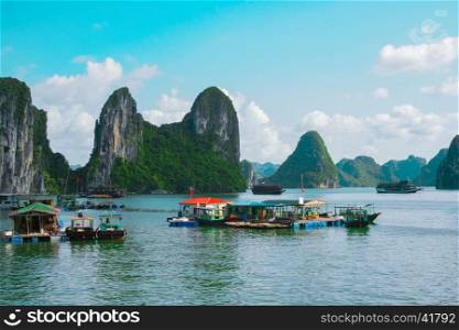Floating fishing village and rock islands in Halong Bay, Vietnam, Southeast Asia. UNESCO World Heritage Site. Junk boat cruise to Ha Long Bay. Most popular landmark, tourist destination of Vietnam