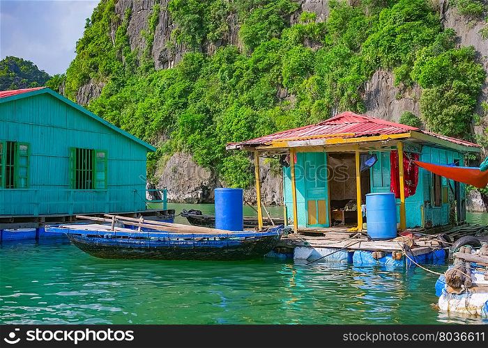 Floating fishing village near mountain islands in Halong Bay, Vietnam, Southeast Asia
