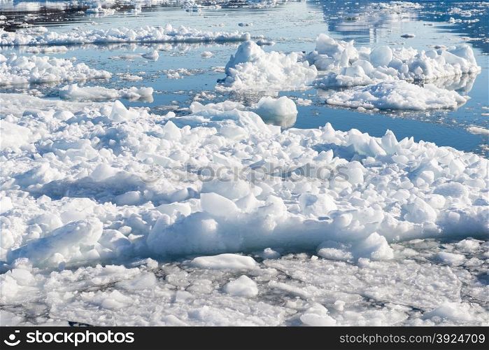 Floating Ice in Greenland. Floating Ice on the Ocean in Greenland with reflections of a blue sky in water