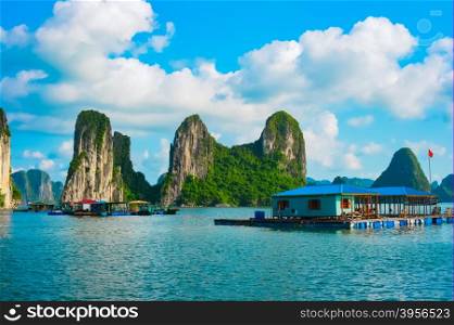Floating village near rock islands in Halong Bay, Vietnam, Southeast Asia. UNESCO World Heritage Site.