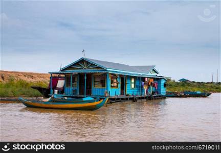 Floating village on Lake Tonle Sap in Cambodia with some houses made from boats