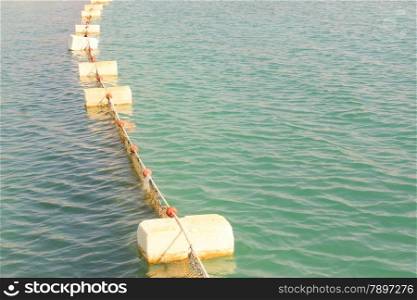 Floats in Water. Set of Buoys. Sea barrage at sun light.