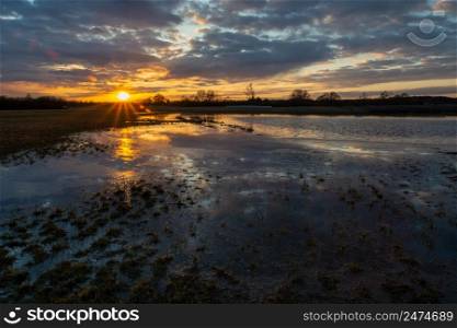 Flooded meadow after downpour, clouds and sunset, Nowiny, Poland