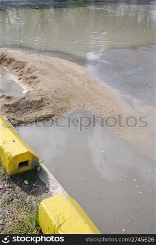 flooded road construction site with gravel material