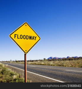 Floodway sign by road in rural Australia.