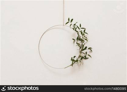 floral and metal construction on white wall background.. floral and metal construction on white wall background