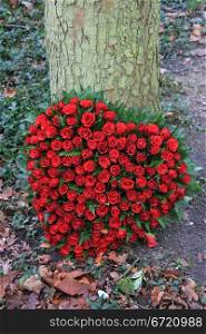 Floral arrangement for funeral in heart shape, red roses