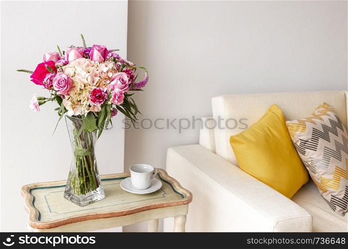 Floral arrangement of roses and hydrangeas decorating the living room of the house