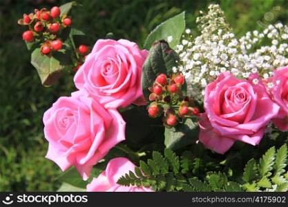 Floral arrangement with big pink roses
