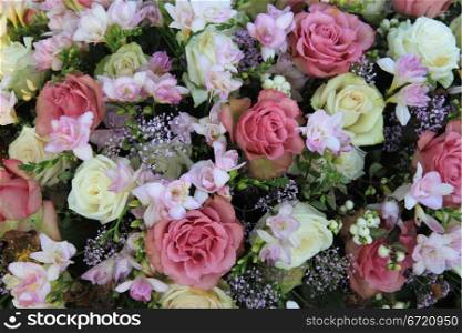 Floral arrangement with different sorts of flowers in pink, lilac, purple and white