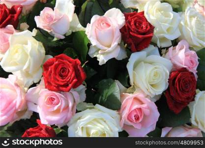 Floral arrangement with red, pink and white roses