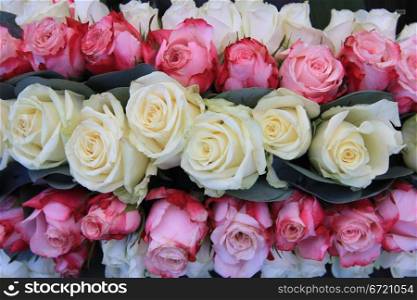 Floral arrangement wth pink and white roses and some leaves